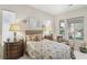 Comfortable bedroom features a decorative bedspread, bedside tables with lamps, and relaxing chair at 10057 Regency Canyon Way, Las Vegas, NV 89148