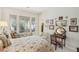 Bedroom featuring a large bed, comfortable furnishings, and access to a private backyard at 10057 Regency Canyon Way, Las Vegas, NV 89148
