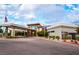 Clubhouse exterior featuring modern architecture, professional landscaping and porte cochere at 10057 Regency Canyon Way, Las Vegas, NV 89148