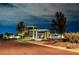 Night view of the community center entrance with modern architecture and landscaped grounds at 10057 Regency Canyon Way, Las Vegas, NV 89148