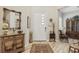Charming foyer featuring a decorative mirror, wood accents, and a glimpse into the home's inviting interior design at 10057 Regency Canyon Way, Las Vegas, NV 89148