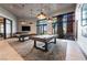 Inviting game room featuring two pool tables, pendant lighting, and large windows offering plenty of natural light at 10057 Regency Canyon Way, Las Vegas, NV 89148