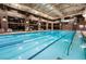 Indoor pool area with lap lanes, comfortable seating, and overhead lighting creates a serene atmosphere at 10057 Regency Canyon Way, Las Vegas, NV 89148