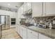 Modern kitchen with stainless steel appliances, white cabinets, and granite countertops at 10057 Regency Canyon Way, Las Vegas, NV 89148