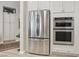 Modern kitchen with stainless steel appliances, white cabinets, and ample storage space at 10057 Regency Canyon Way, Las Vegas, NV 89148