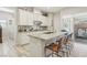 Open kitchen with island seating, stainless steel appliances, and granite countertops at 10057 Regency Canyon Way, Las Vegas, NV 89148