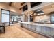 Modern kitchen area featuring stainless steel appliances, a large island, and adjacent game room for entertaining at 10057 Regency Canyon Way, Las Vegas, NV 89148