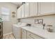 Functional laundry room with front-loading washer and dryer, and ample storage space at 10057 Regency Canyon Way, Las Vegas, NV 89148