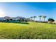 Expansive green lawn with modern buildings and palm trees in the background, perfect for outdoor activities at 10057 Regency Canyon Way, Las Vegas, NV 89148