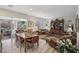 Open floor plan with a living area, dining space, and sliding glass doors leading to outdoor patio at 10057 Regency Canyon Way, Las Vegas, NV 89148