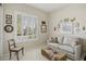 Bright room with large windows, shutters, love seat, and soft colored carpet at 10057 Regency Canyon Way, Las Vegas, NV 89148