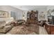 Inviting living room with a large rug, comfortable seating, and built-in bookcase for storage at 10057 Regency Canyon Way, Las Vegas, NV 89148