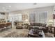 Spacious living room featuring ample seating, natural light, and an open layout for entertaining at 10057 Regency Canyon Way, Las Vegas, NV 89148