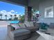 A covered patio with a large sectional couch provides comfortable seating next to the community pool at 10057 Regency Canyon Way, Las Vegas, NV 89148