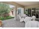 Covered patio with brick flooring, chairs, and a table, perfect for outdoor dining and entertaining at 10057 Regency Canyon Way, Las Vegas, NV 89148