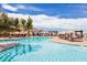 An inviting community pool with shaded seating offers a refreshing retreat for residents and guests alike at 10057 Regency Canyon Way, Las Vegas, NV 89148