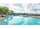 A large outdoor pool with lounge chairs is surrounded by palm trees and is an oasis for relaxing at 10057 Regency Canyon Way, Las Vegas, NV 89148