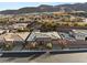 Aerial view of a desert home featuring mature landscaping, a stone exterior, and located with mountain views at 10179 Emerald Sunset Ct, Las Vegas, NV 89148