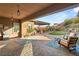 Inviting back patio with pavers, lounge chairs and pergola, perfect for outdoor relaxation at 10179 Emerald Sunset Ct, Las Vegas, NV 89148