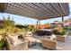Backyard with a covered outdoor seating area, pergola and hot tub at 10179 Emerald Sunset Ct, Las Vegas, NV 89148