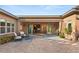 A well-manicured backyard featuring a brick patio, plantings, and open access to the house at 10179 Emerald Sunset Ct, Las Vegas, NV 89148