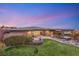 Expansive backyard with manicured lawn, covered patio, hot tub, and elegant landscaping for outdoor enjoyment at 10179 Emerald Sunset Ct, Las Vegas, NV 89148