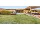 Well-manicured backyard featuring a lush green lawn and hot tub, creating a serene and inviting atmosphere at 10179 Emerald Sunset Ct, Las Vegas, NV 89148