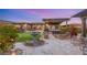 Beautiful backyard featuring a stone pathway, fountain, hot tub, pergola, and lush landscaping at 10179 Emerald Sunset Ct, Las Vegas, NV 89148