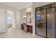 Lovely bathroom area with vanity, mirror, tiled floors and a glass enclosed shower at 10179 Emerald Sunset Ct, Las Vegas, NV 89148
