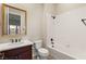 Bathroom features white subway tile shower, framed mirror, and wood vanity at 10179 Emerald Sunset Ct, Las Vegas, NV 89148