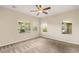 Carpeted bedroom with views of the lushly landscaped backyard and patio at 10179 Emerald Sunset Ct, Las Vegas, NV 89148