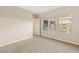 Bright bedroom features neutral walls, carpet flooring, and three windows overlooking the exterior at 10179 Emerald Sunset Ct, Las Vegas, NV 89148
