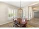 Cozy dining room featuring a decorative chandelier and natural light from shuttered windows at 10179 Emerald Sunset Ct, Las Vegas, NV 89148