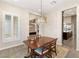 Formal dining room with wood table and chairs, carpeted floors and natural lighting at 10179 Emerald Sunset Ct, Las Vegas, NV 89148