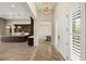 Grand entryway leading to the kitchen and dining room with wood-look tile floors at 10179 Emerald Sunset Ct, Las Vegas, NV 89148