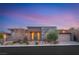 Beautiful single-story home featuring a low-maintenance front yard and a modern color palette at dusk at 10179 Emerald Sunset Ct, Las Vegas, NV 89148