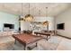 The recreational space features a contemporary pool table, comfortable seating, and a large screen TV for entertainment at 10179 Emerald Sunset Ct, Las Vegas, NV 89148