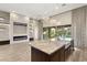 Open kitchen features pendant lighting, granite countertops, dark wood cabinets, and stainless appliances at 10179 Emerald Sunset Ct, Las Vegas, NV 89148