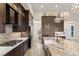 Gourmet kitchen features a gas range, stainless steel appliances, and dark wood cabinetry at 10179 Emerald Sunset Ct, Las Vegas, NV 89148