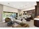 Staged kitchen features dark wood cabinets, pendant lighting, tile floors, and backyard view at 10179 Emerald Sunset Ct, Las Vegas, NV 89148