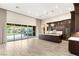 Open kitchen with sliding glass door, dark wood cabinets, tile floors, and a view to the backyard at 10179 Emerald Sunset Ct, Las Vegas, NV 89148