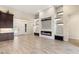 Open living room with custom fireplace, shelving, recessed lights, and tile floors at 10179 Emerald Sunset Ct, Las Vegas, NV 89148