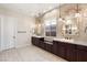 Luxury main bathroom features dual vanities, granite counters and decorative lighting at 10179 Emerald Sunset Ct, Las Vegas, NV 89148