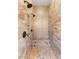 Close up of the dual head tiled shower with a stone seat and bronze fixtures at 10179 Emerald Sunset Ct, Las Vegas, NV 89148