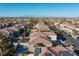 An aerial view of a neighborhood with tile roofs and views of the city at 10273 Grecian Laurel Ct, Las Vegas, NV 89183