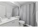 Bright bathroom features a large mirror, vanity, and shower-tub combination at 10273 Grecian Laurel Ct, Las Vegas, NV 89183