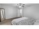 Cozy bedroom with a ceiling fan, carpet flooring, and a full-length mirror at 10273 Grecian Laurel Ct, Las Vegas, NV 89183