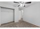 Cozy carpeted bedroom features a ceiling fan and closet for functional living at 10273 Grecian Laurel Ct, Las Vegas, NV 89183