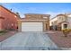 Two-story home with a tile roof and wide driveway at 10273 Grecian Laurel Ct, Las Vegas, NV 89183
