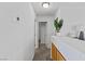 Clean hallway with neutral walls, carpet flooring, and access to various rooms in the home at 10273 Grecian Laurel Ct, Las Vegas, NV 89183